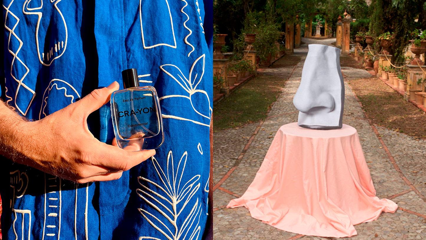 Art meets scent: CRA-YON perfume in bold blue paired with a surreal sculpture in a garden setting.