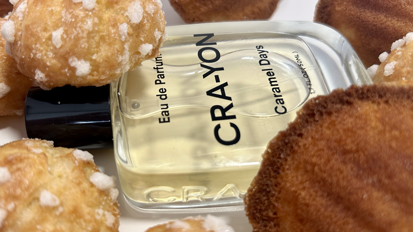 CRA-YON Caramel Days perfume bottle surrounded by golden madeleines and sugar-topped pastries