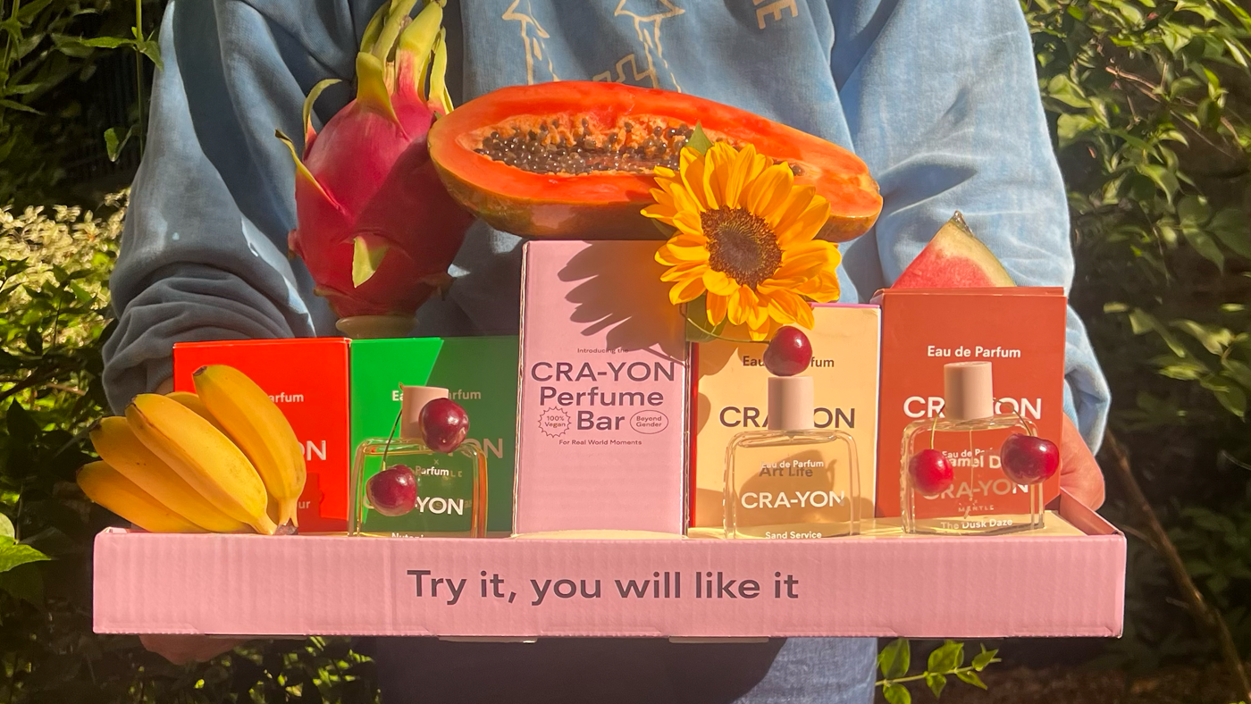 CRA-YON Perfume Bar tray with tropical fruits, 4 Eau de Parfums, and slogan: Try it, you will like it.
