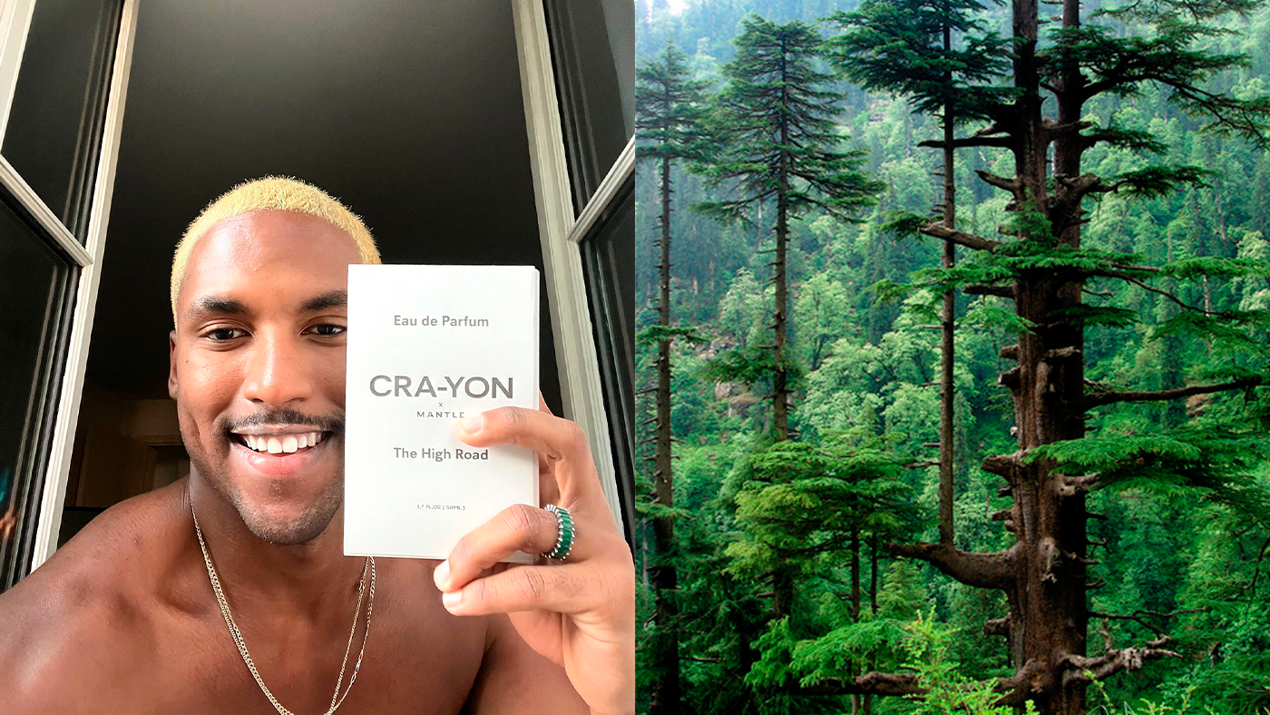 Smiling person holding CRA-YON 'The High Road' perfume box next to lush green forest scene