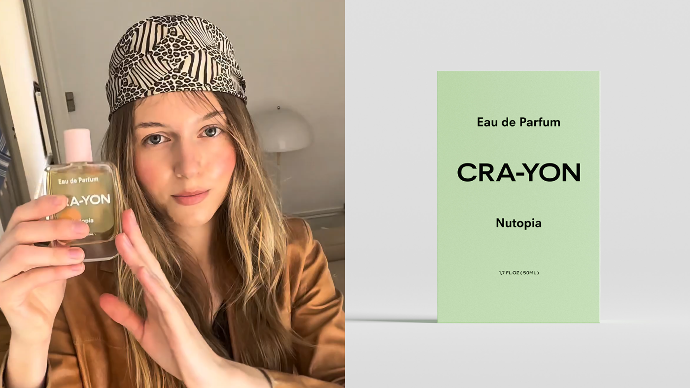 Person holding CRA-YON 'Nutopia' perfume bottle next to product packaging in mint green on white background
