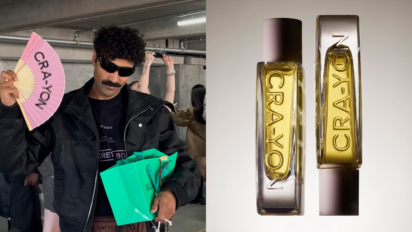 CRA-YON perfumes – fashionable man with pink fan and bag next to two modern CRA-YON fragrance bottles for niche scent lovers.