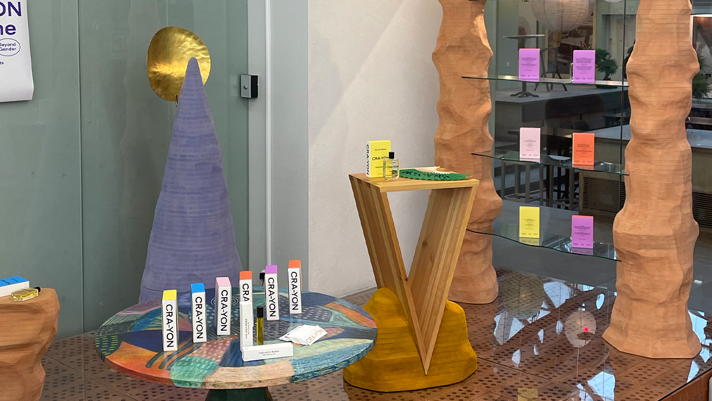 Colorful CRA-YON perfume display with tester sticks and scent wardrobe at a curated concept store installation.