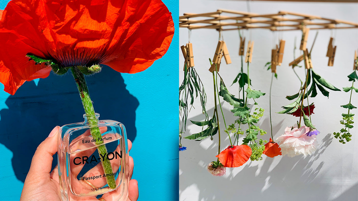 CRA-YON floral perfume bottle with bold red poppy and hanging flower installation