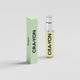 CRA-YON Nutopia travel-size perfume bottle with a silver cap beside its pale green box on a light grey background.