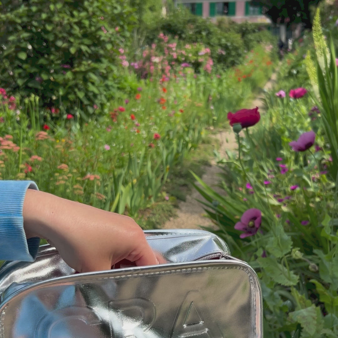 CRA-YON Perfume The Dusk Daze in a blooming garden.