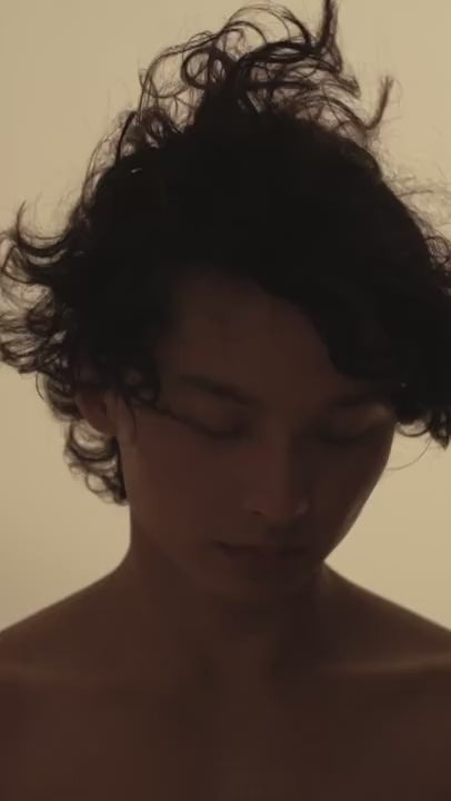 Boy moving his head smelling young air.